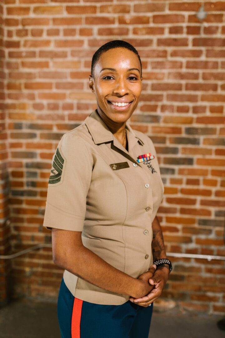 A woman in uniform smiling for the camera.